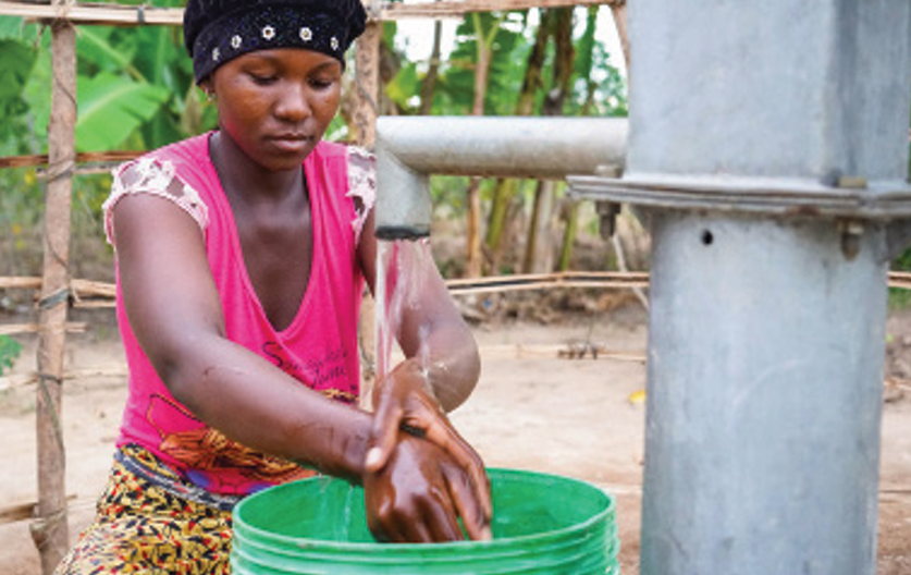 Woman washing hands at pump