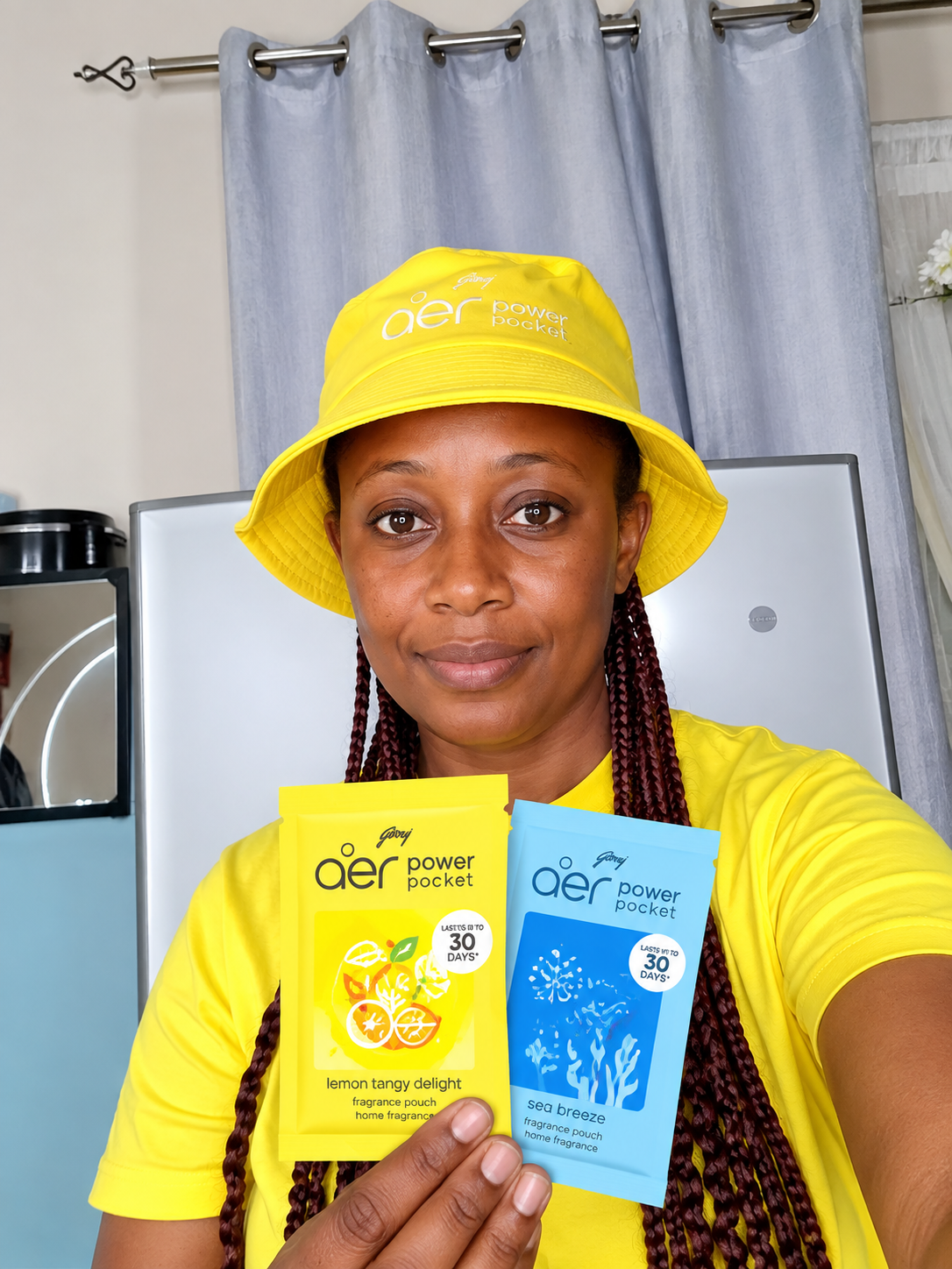 Influencer in AER branded cap holding Power Pocket sachets