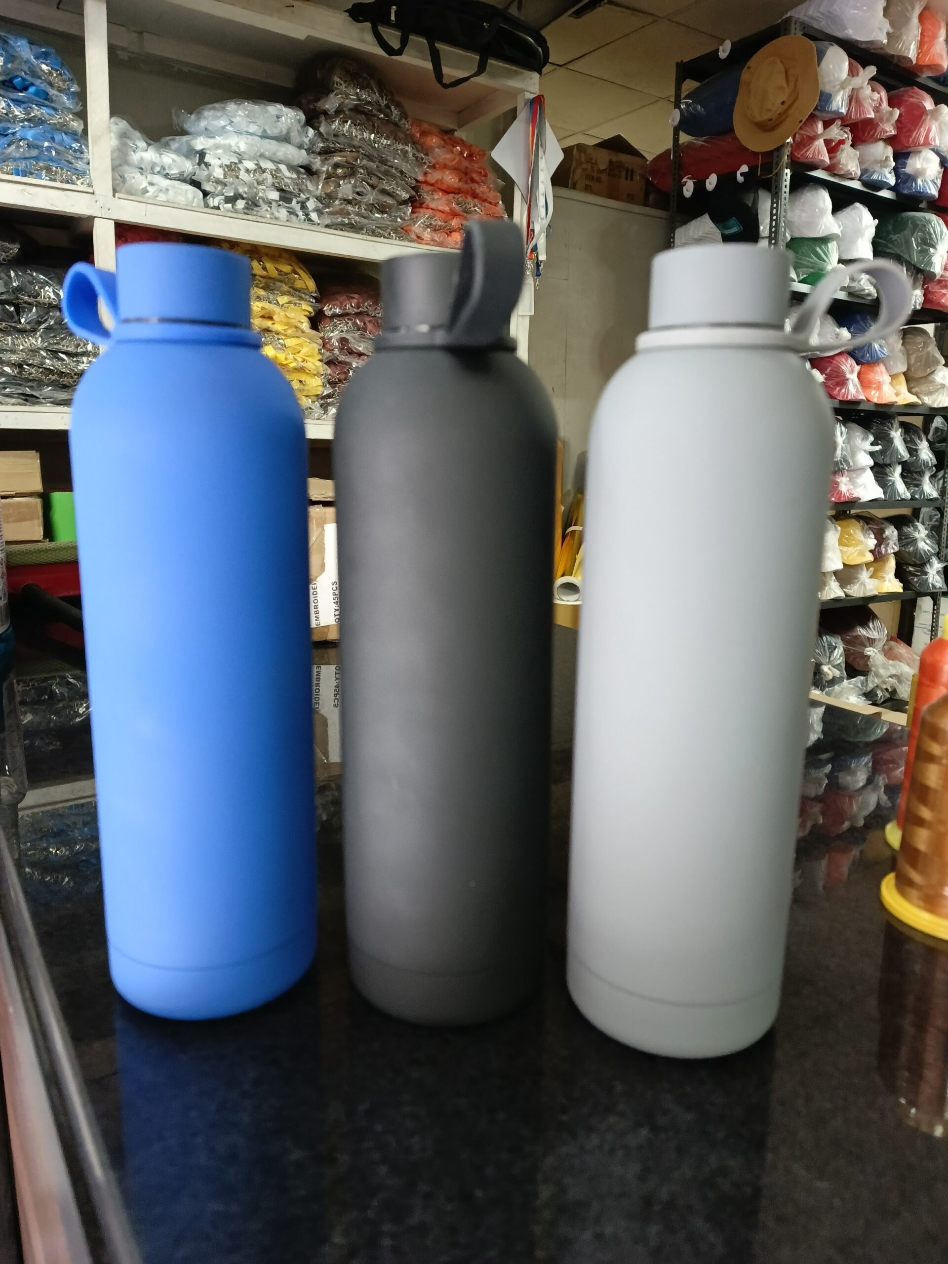 Powder-coated branded water bottles in three colourways