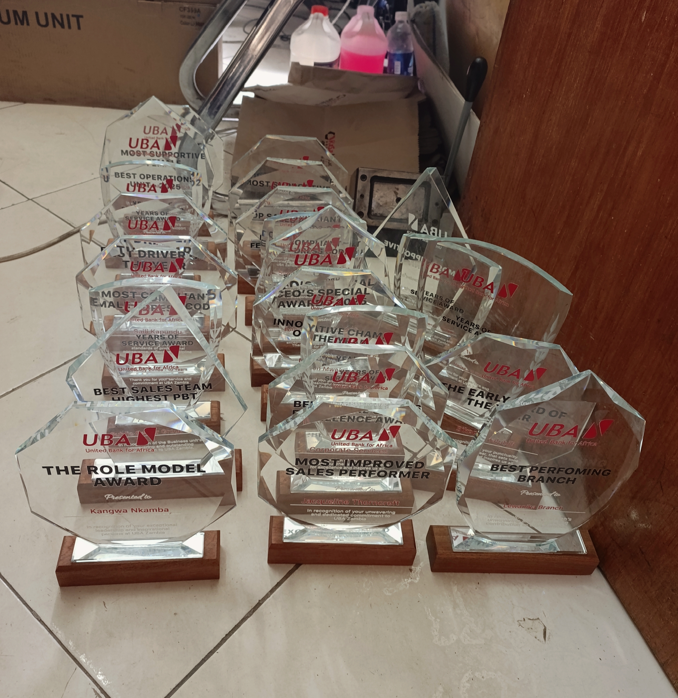 Batch of engraved glass awards prepared for a client ceremony
