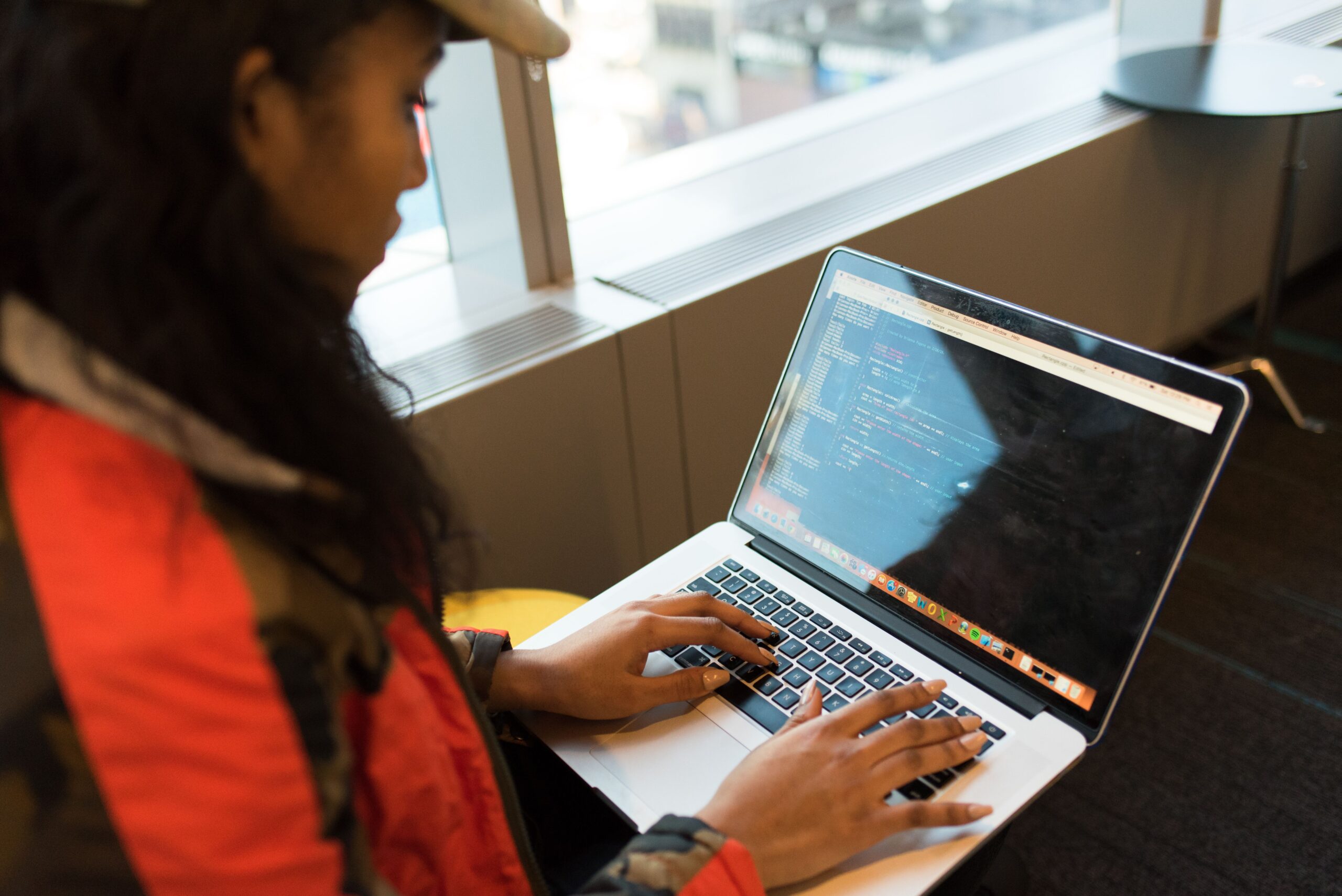Developer typing code on a laptop